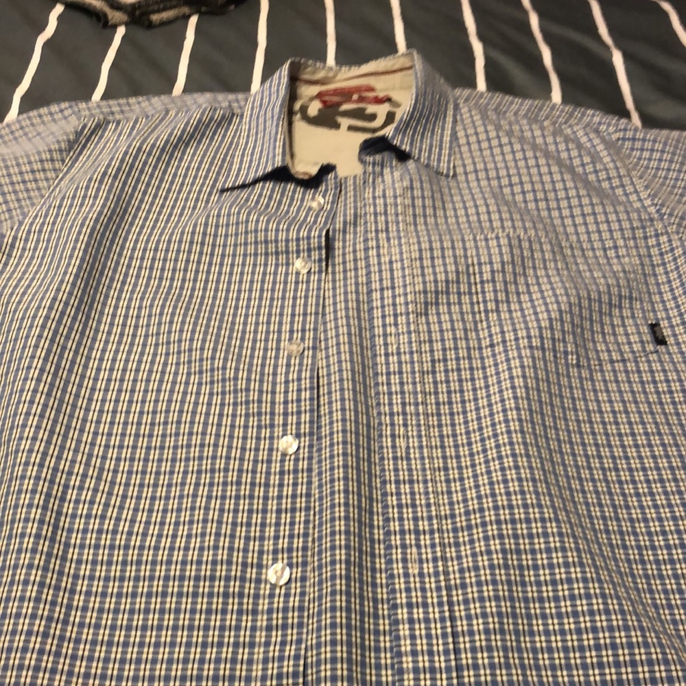 Checkered short sleeve.  Very roomy.  Looks gray but it’s really blue pattern